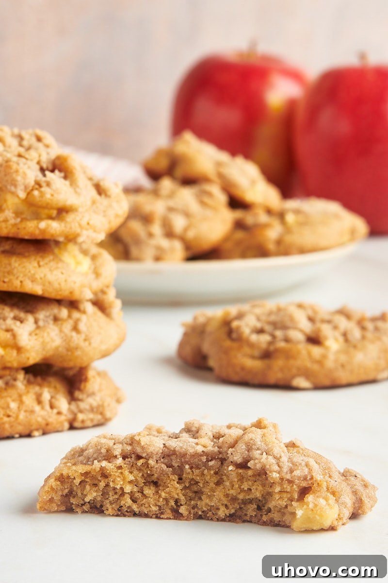 A partial crumb-topped apple cookie with more cookies in the background.