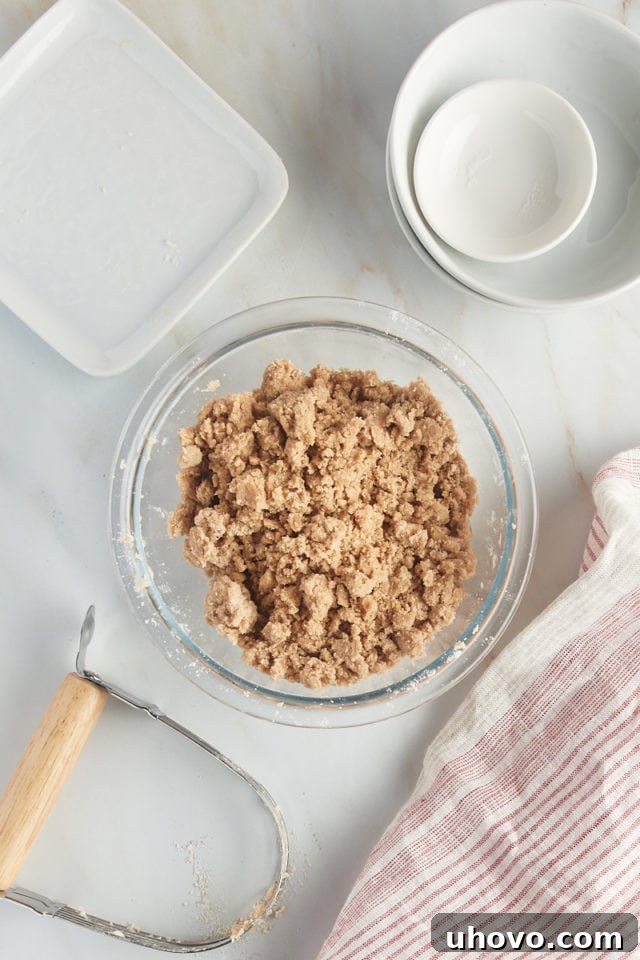 Overhead view of mixed crumb topping in a glass mixing bowl.