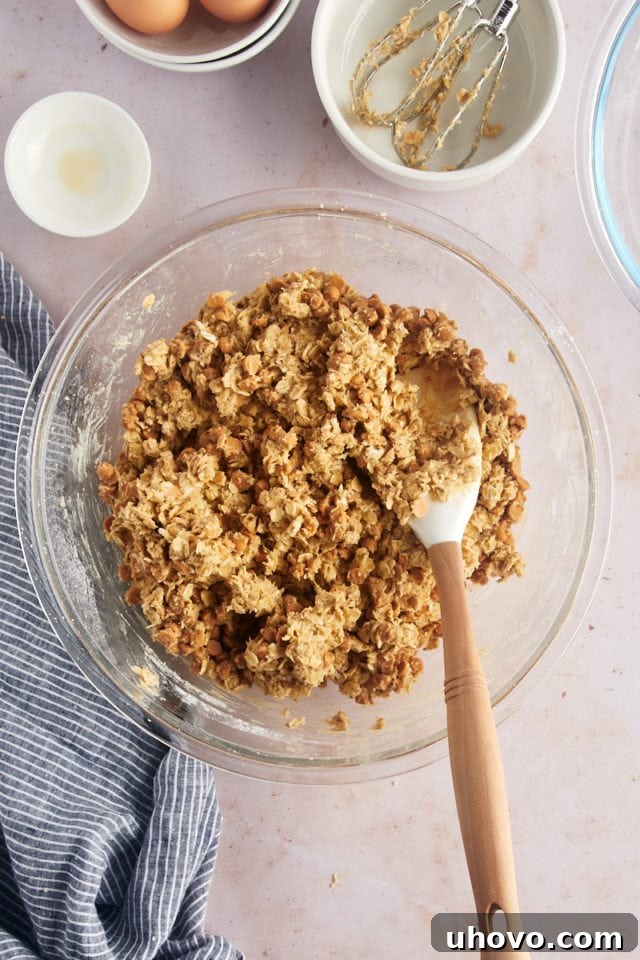 Overhead view of oatmeal butterscotch cookie dough in glass bowl