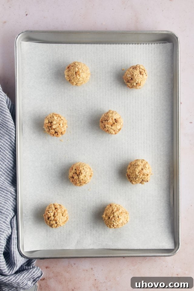 Overhead view of dough balls on parchment-lined baking sheet