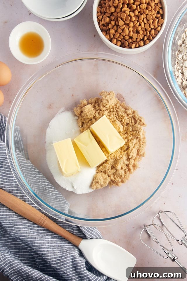 Overhead view of butter and sugars in glass bowl