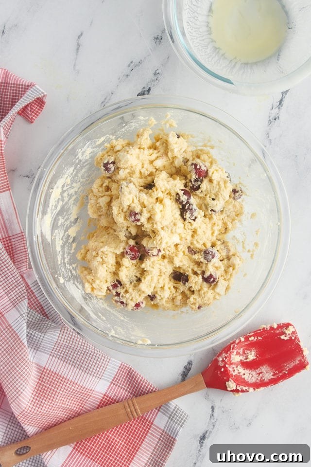 overhead view of cranberry orange scone dough in a glass mixing bowl