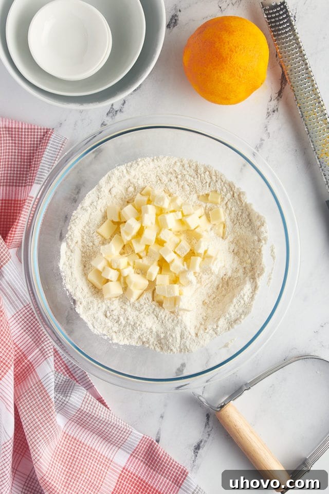 overhead view of butter added to dry ingredients for cranberry orange scones