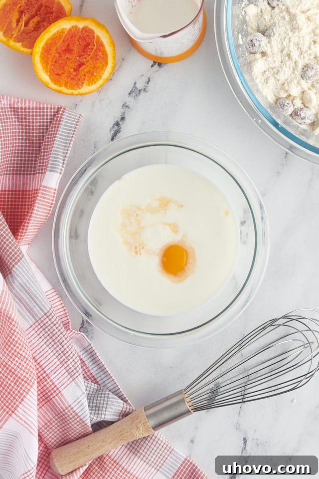 overhead view of buttermilk, egg yolk, and orange juice in a small glass bowl