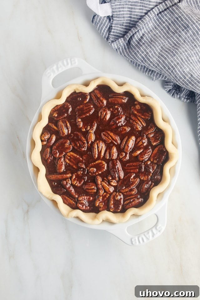 overhead view of chocolate pecan pie ready to go into the oven