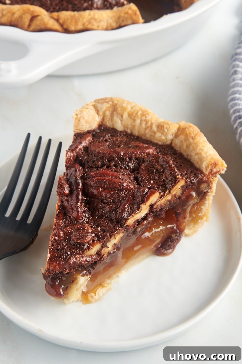a slice of chocolate pecan pie on a white plate