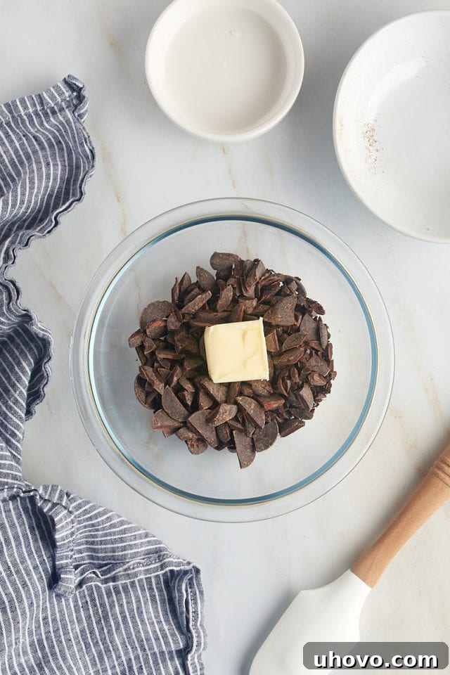 overhead view of chocolate and butter in a glass bowl