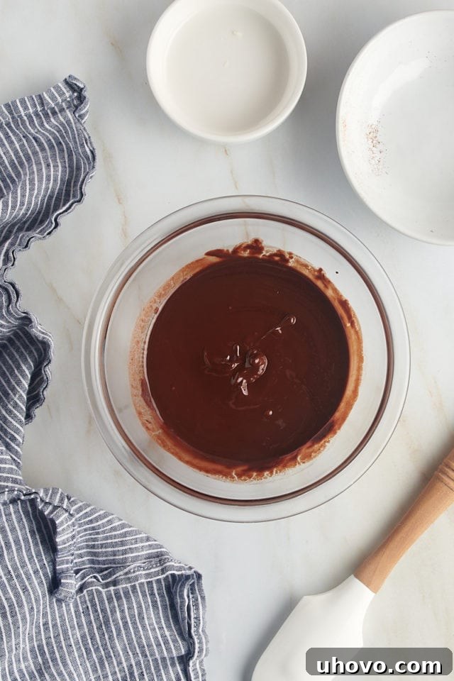 overhead view of melted chocolate and butter in a glass bowl