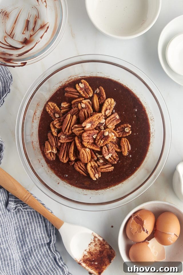 overhead view of pecans added to pie filling