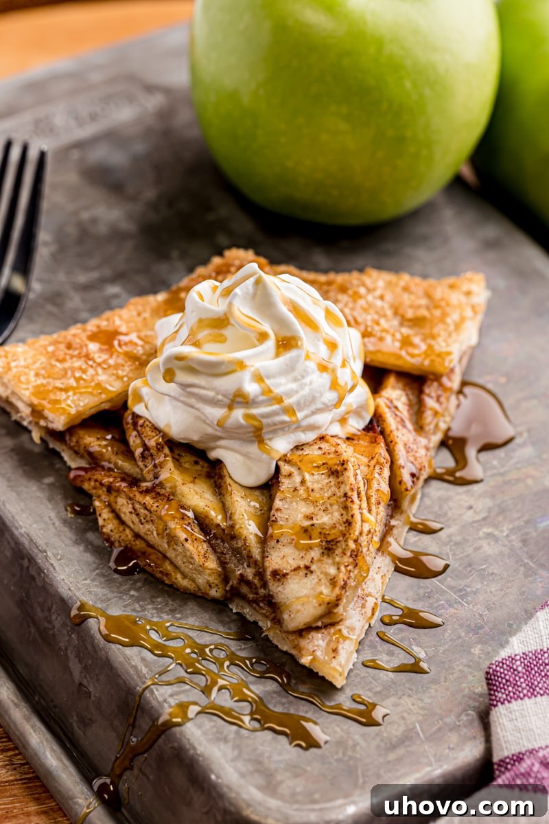 a slice of apple galette topped with whipped cream and caramel