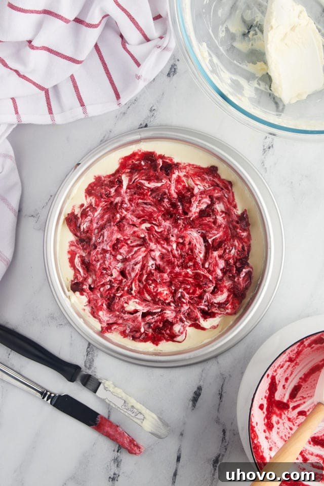 overhead view of assembled no-bake cranberry cheesecake ready to go into the refrigerator
