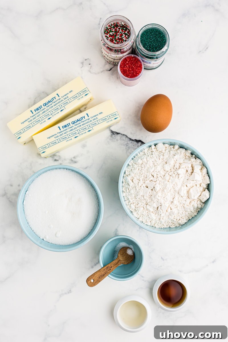 An overhead view of the simple, essential ingredients for making spritz cookies laid out on a surface.