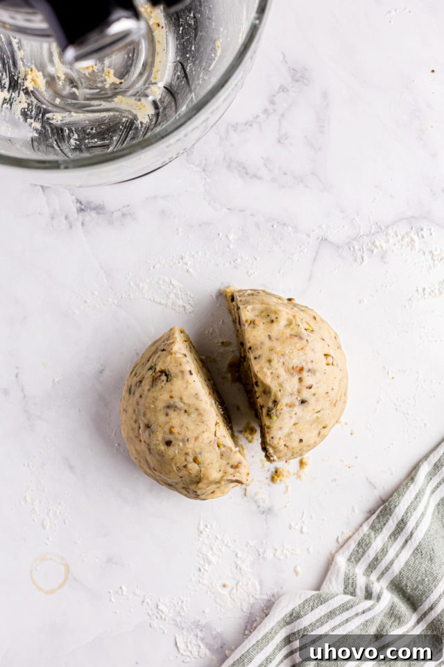 overhead view of pistachio cookie dough divided in half