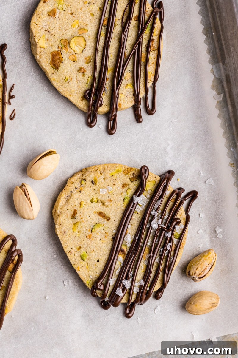 overhead view of pistachio cookies drizzled with melted dark chocolate