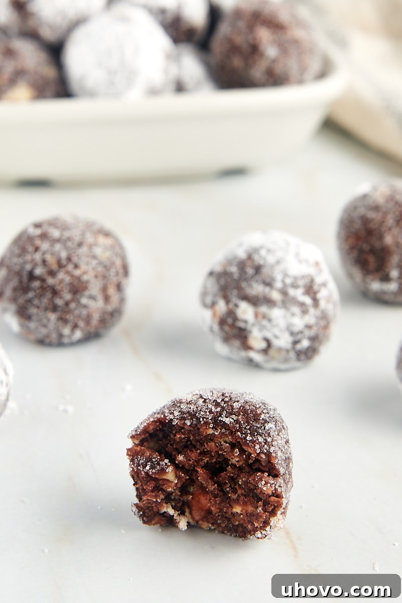 half of a bourbon ball with more bourbon balls in the background