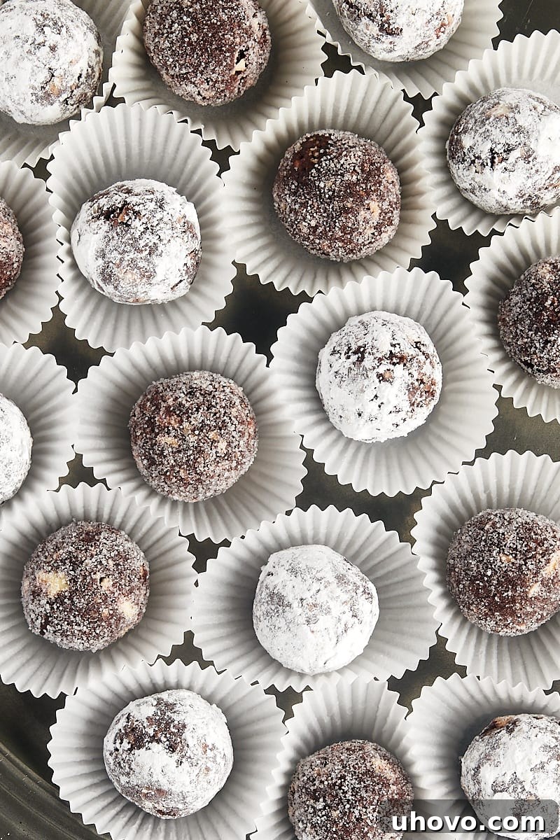 overhead view of several bourbon balls in individual white paper cups