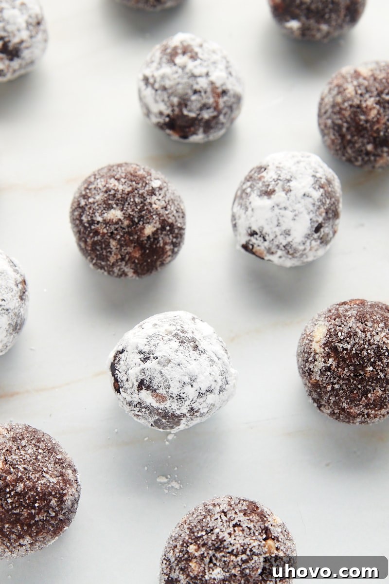 bourbon balls scattered on a marble countertop