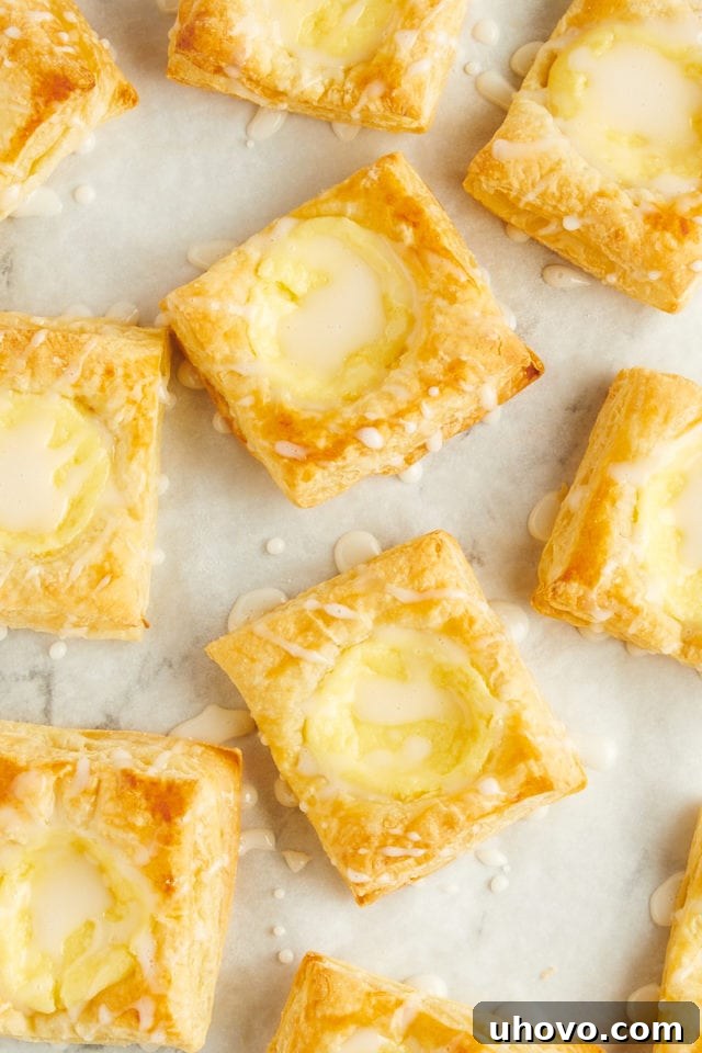 Overhead view of cheese danishes after adding glaze