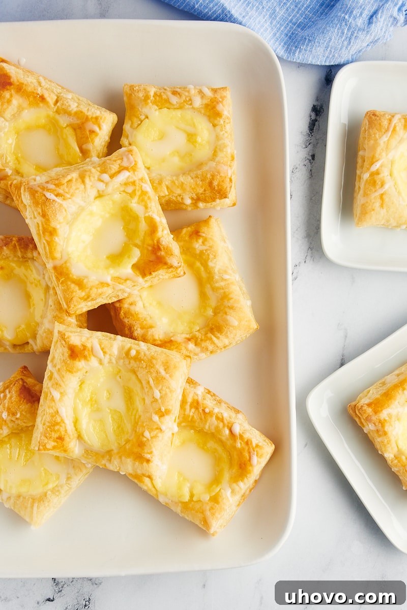 Overhead view of homemade cheese danishes on platter and plates