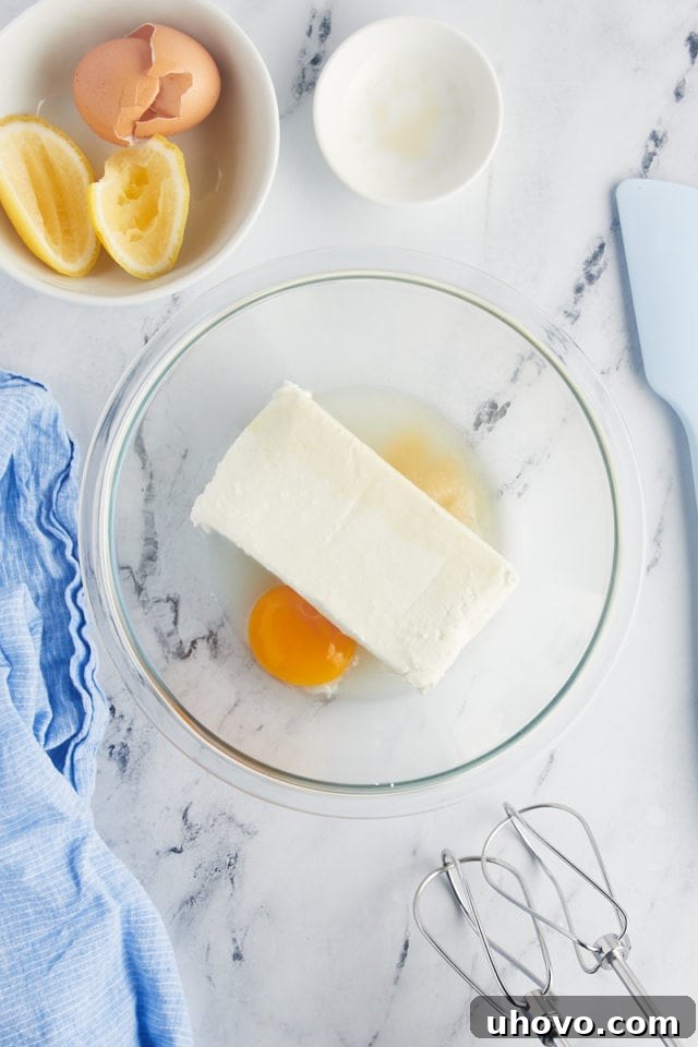Overhead view of cream cheese filling ingredients in glass bowl