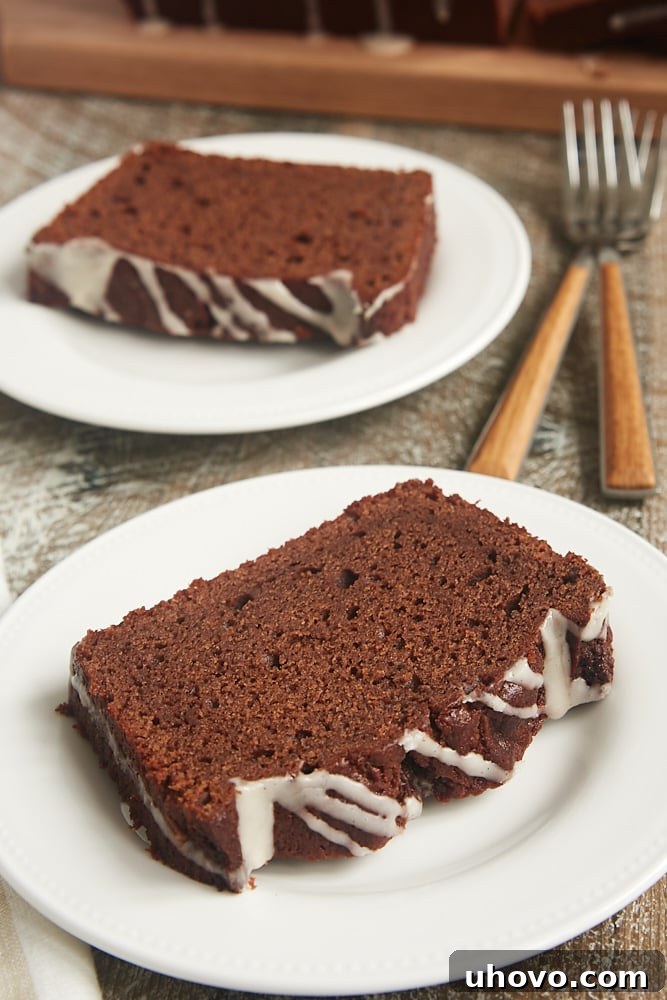 A slice of Chocolate Sour Cream Pound Cake beautifully topped with a simple, elegant vanilla glaze.