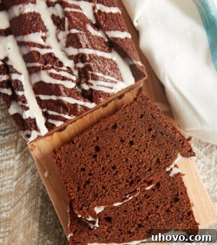 Slices of Chocolate Pound Cake with Vanilla Bean Glaze on a cutting board, garnished beautifully.