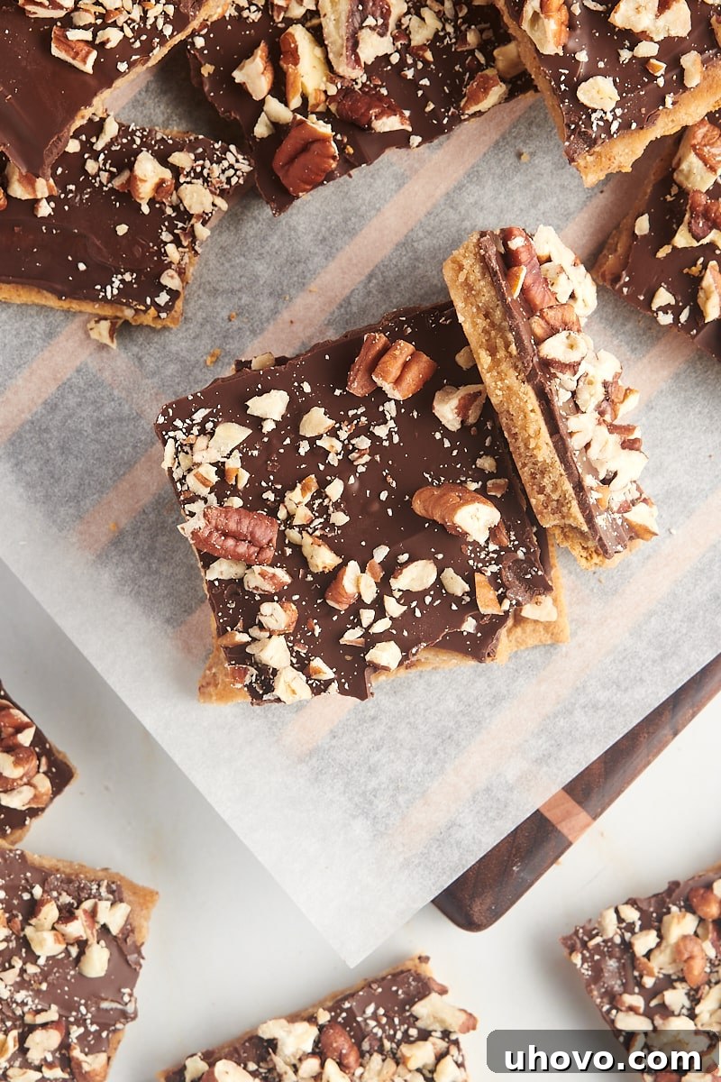 Overhead view of a beautiful stack of Graham Cracker Toffee, surrounded by more scattered pieces, creating an appealing visual.