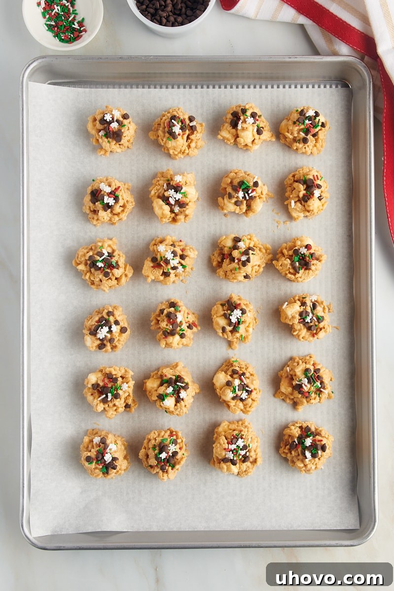 overhead view of avalanche cookies on a parchment-lined baking sheet
