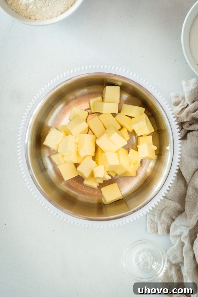 Overhead view of butter pieces in mixing bowl