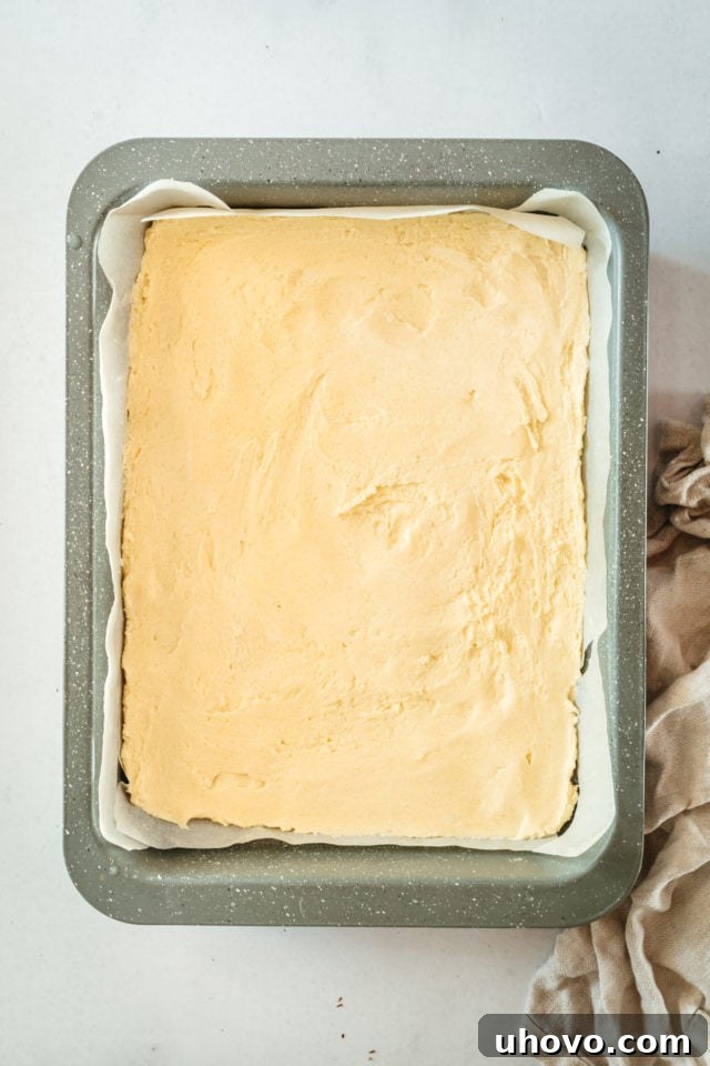Overhead view of unbaked shortbread crust in baking pan