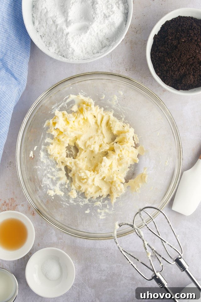 Overhead view of creamy, beaten butter in a mixing bowl, ready for frosting.