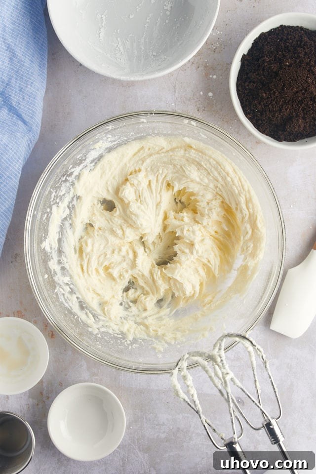 Overhead view of smooth and creamy frosting in a mixing bowl, ready for the Oreo crumbs.