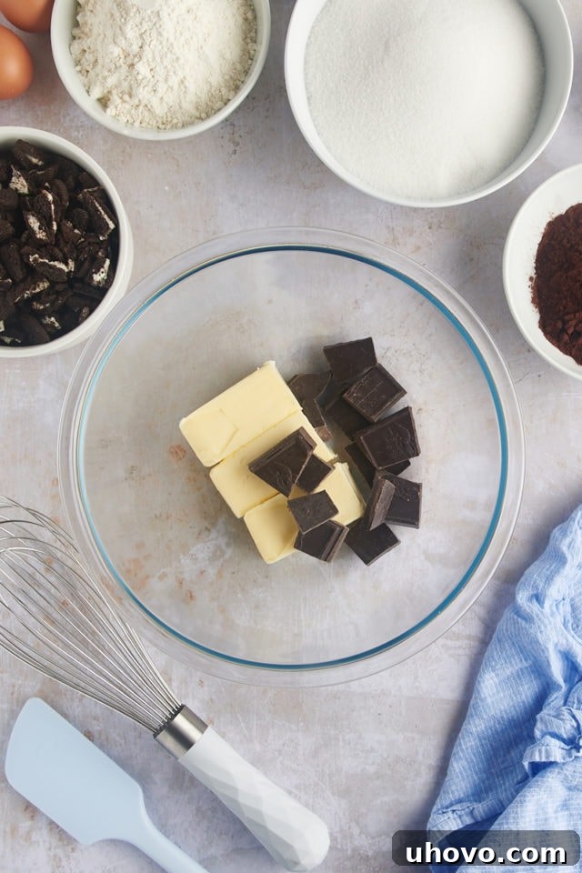Overhead view of butter and chocolate in a mixing bowl, ready to be melted.