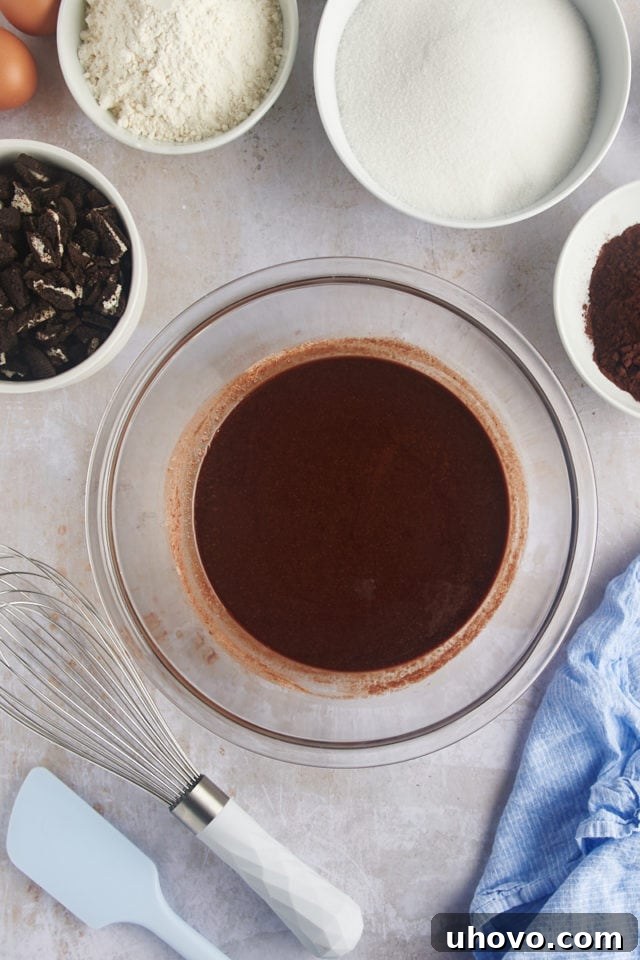 Overhead view of melted butter and chocolate, smoothly combined in a mixing bowl.