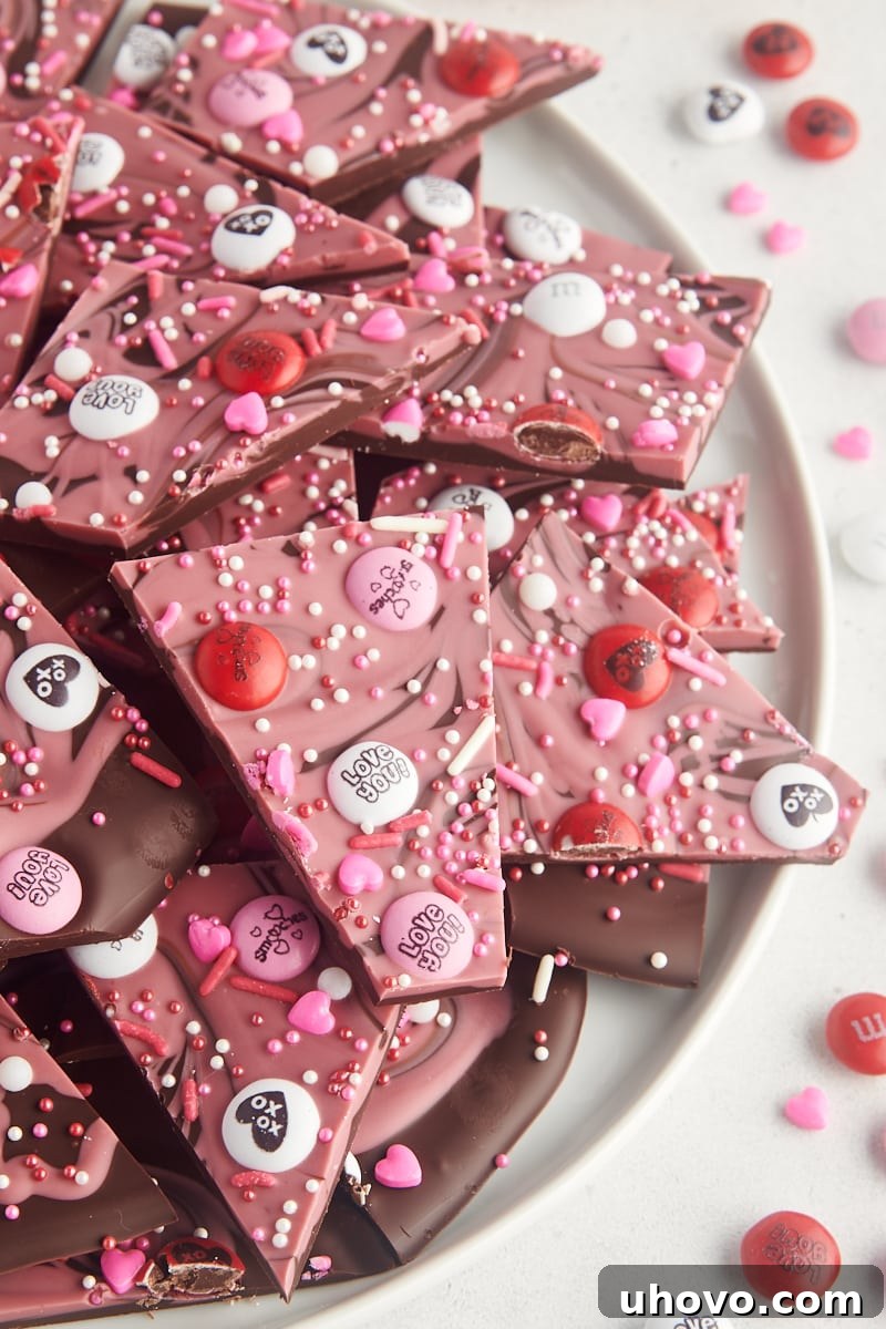 Marbled Valentine's Bark piled on a large white plate, showcasing a beautiful swirl of pink and dark chocolate.