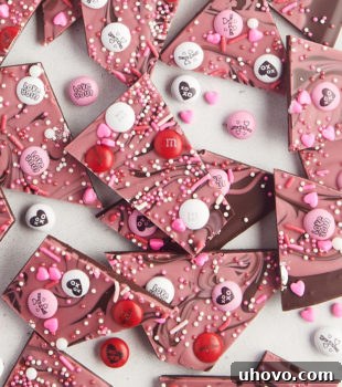 Overhead view of several pieces of marbled Valentine's bark on a white surface, showcasing the beautiful two-toned effect.