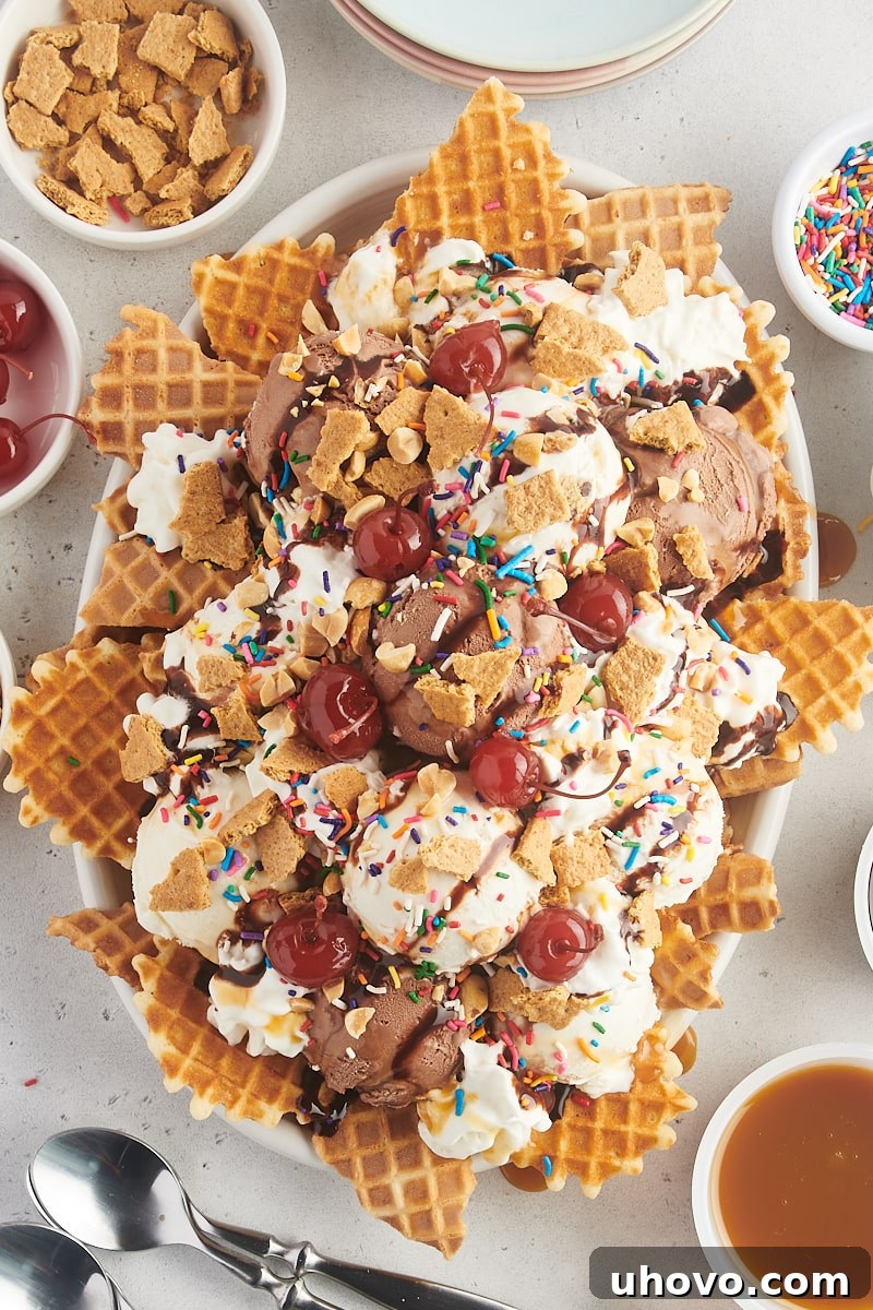 Overhead view of a generous platter of vibrant ice cream nachos, artfully arranged with various ice cream scoops, colorful sprinkles, and sauces, ready to be enjoyed.