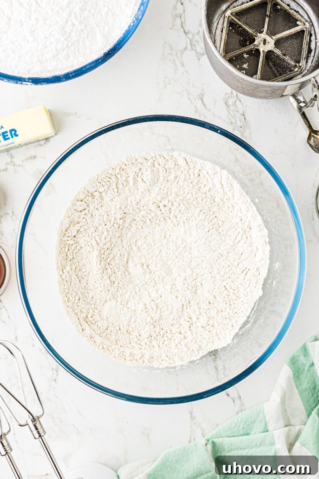 Overhead view of a white bowl containing perfectly sifted dry ingredients for Lofthouse cookies.