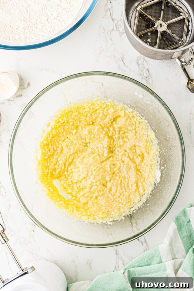 Overhead view of thoroughly mixed wet ingredients for Lofthouse cookies, forming a smooth, unified mixture.