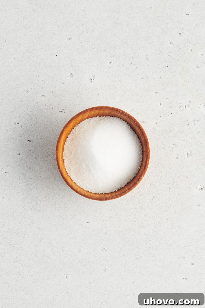 overhead view of table salt in a wooden bowl