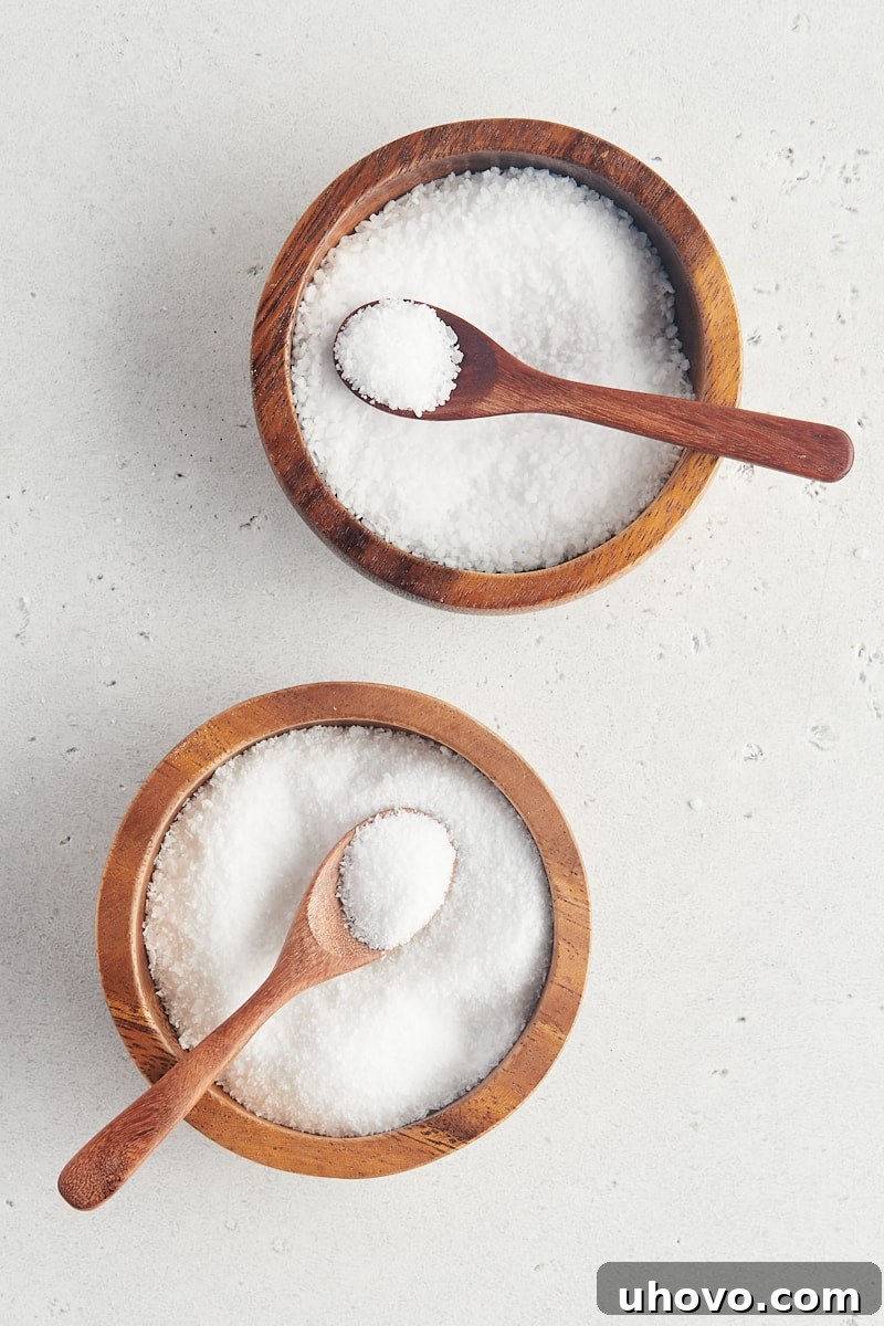 overhead view of two wooden bowls filled with kosher salt