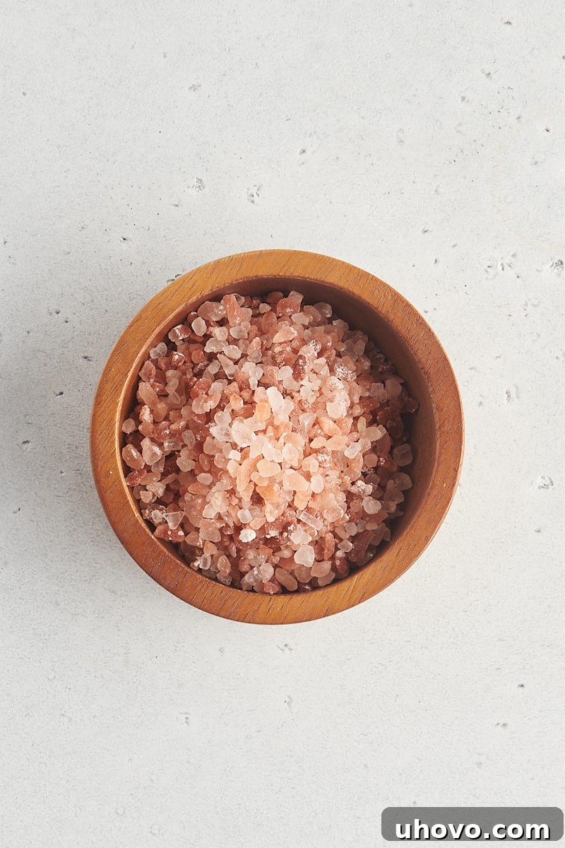 overhead view of Himalayan pink salt in a wooden bowl