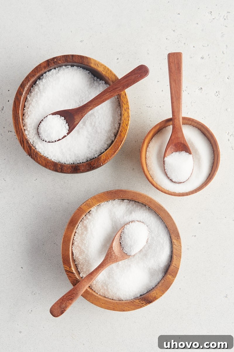 overhead view of three different salts in wooden bowls