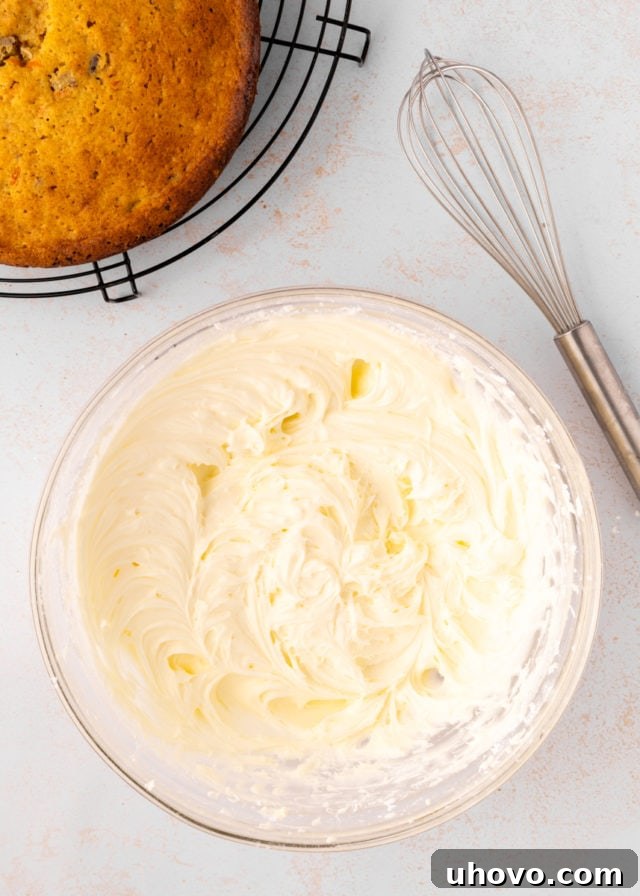 overhead view of cream cheese frosting in a glass mixing bowl