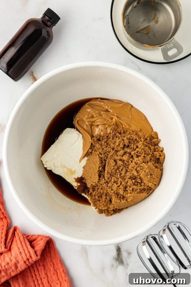 Mixing bowl with peanut butter, brown sugar, cream cheese, and vanilla