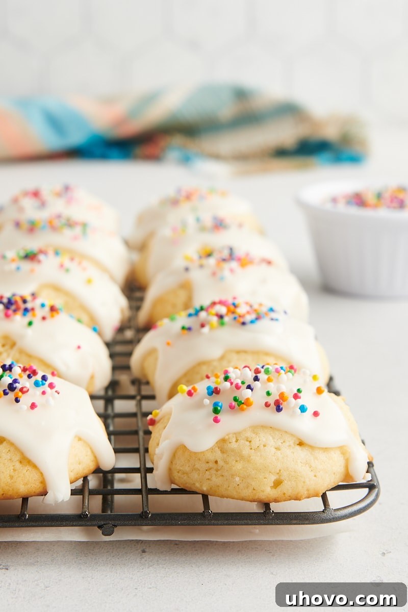 glazed sour cream cookies lined up on a wire cooling rack