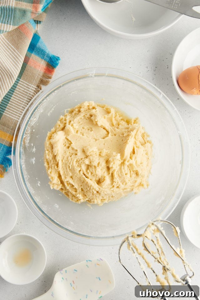 overhead view of mixed sour cream cookie dough in a glass mixing bowl