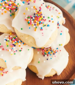 close-up view of sour cream cookies on a small wooden cake stand