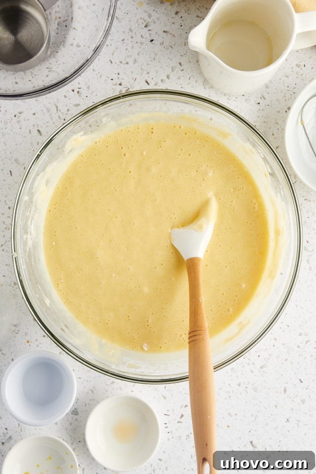 overhead view of olive oil cake batter in a glass mixing bowl