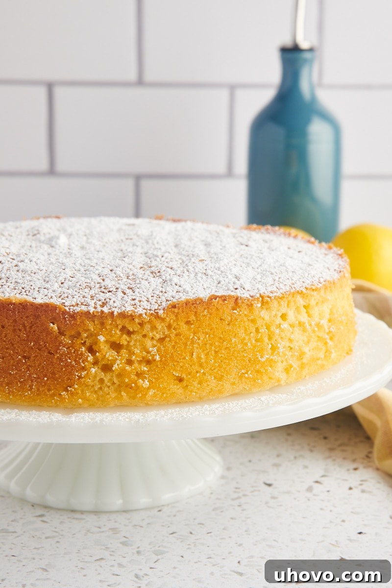 olive oil cake on a white cake stand